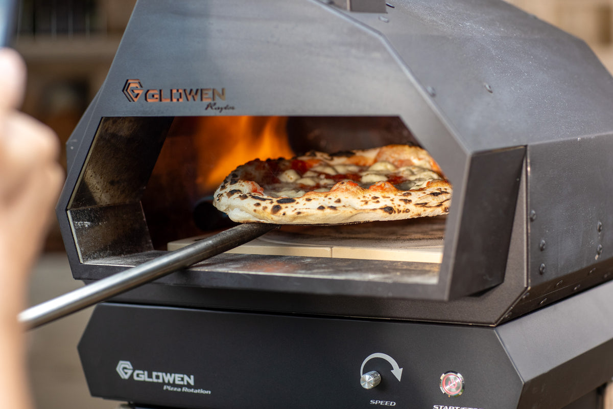 Pizza baking in the Glowen Raptor 1 oven on its autorotation base.